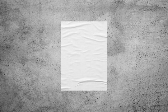 Blank white wheatpaste glued paper poster mockup on concrete wall background