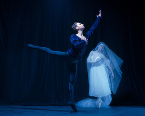 Graceful balerina in image of ghost bride with patner in art ballet performance isolated over dark background. © Lustre Art Group 