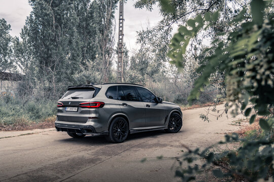 New SUV BMW X5 G05 on the empty road. Kherson, Ukraine - May 2021. 