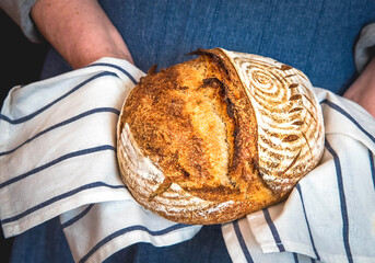 Female hands holding freshly baked homemade bread