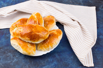 Delicious little pies with green onion and egg. Traditional Russian cuisine. Homemade cakes.