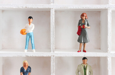 miniature people standing side by side. family concept
