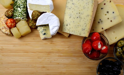 cheeseboard with camenbert, blue cheese, cheese with herbs and pepper and more