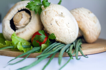 washed vegetables and mushrooms with herbs on a cutting board