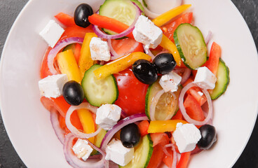 Greek salad with vegetables feta and olives top view close up