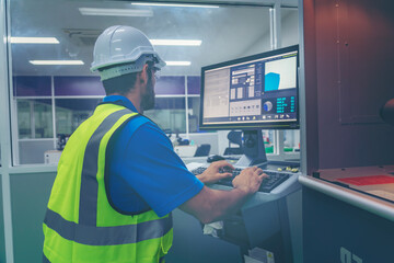 Male industrial engineer or technician worker using control machine operating control CNC machinery at factory Industrial.