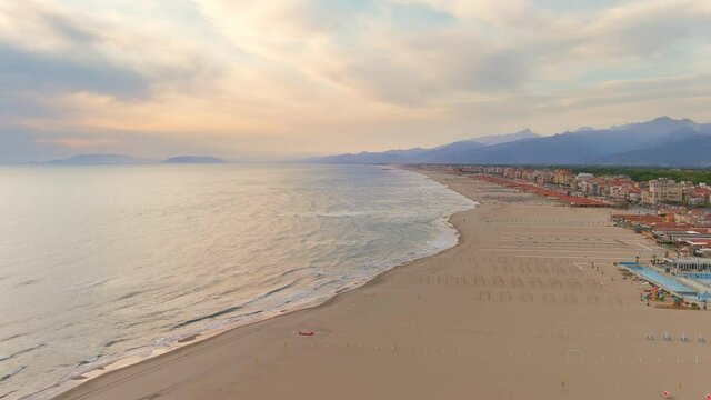 Viareggio, Italy - Aerial view of summer resort town in Tuscany, golden sand of famous beaches of Apuan Riviera and Versilia at sunset, colorful sky - landscape panorama of Europe from above - HDR