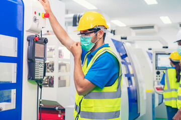 Male industrial engineer or technician worker using control machine operating control CNC machinery at factory Industrial.