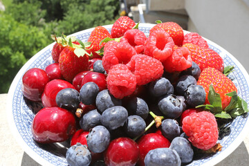 Fresh fruits and berries on daylight