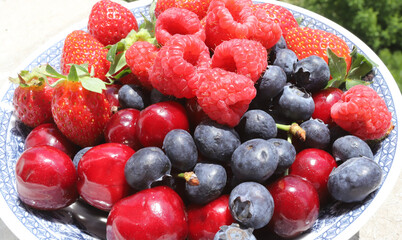 Close up of fresh fruits and berries on daylight