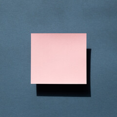Pink Memo pad on navy blue background. top view, copy space