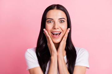 Close-up portrait of charming amazed cheerful girl enjoying good news reaction isolated over pink pastel color background