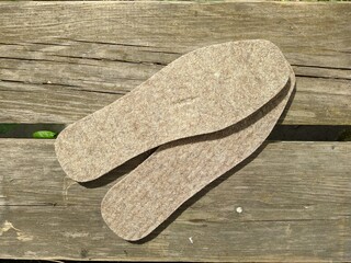 warm insoles for shoes on a wooden background