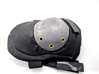 one old and shabby knee pad on a white background