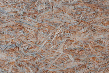 Old scuffed surface of water-resistant osb board close-up