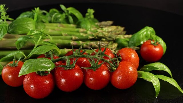 Cherry tomatoes, green basil leaves and asparagus