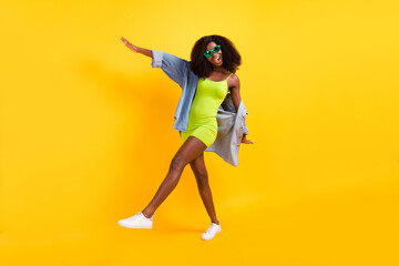 Fototapeta na wymiar Full length body size photo of girl in stylish short dress sunglass laughing overjoyed isolated vibrant yellow color background