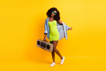 Full length body size photo of girl in sunglass dancing keeping retro tape recorder in summer...