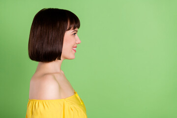 Profile side photo of charming happy nice young woman look empty space isolated on shine green color background