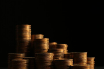 A large variety of coins on a black background. Stack of coins. Close up