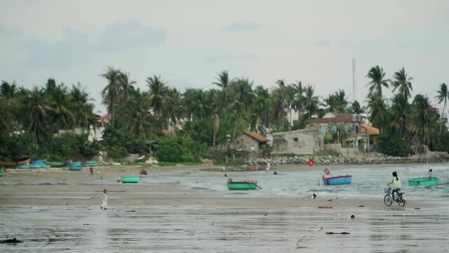 Mui Ne Beach Vietnam near to the Fishing Village - Traditional basket boats line the shores - Right to left panning shot