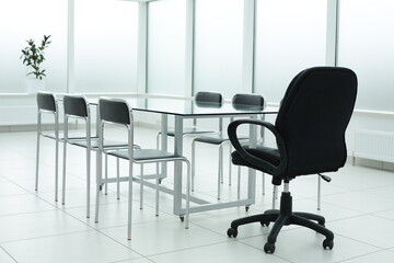 Laptop on glass table in spacious office space
