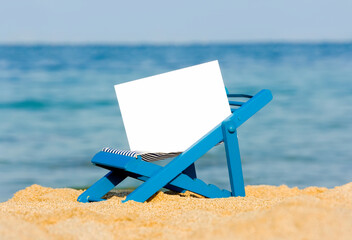 Fototapeta na wymiar A Deckchair with a Signpost on the Beach, Selective Focus