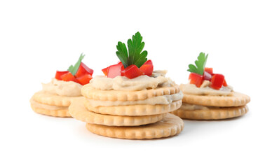 Delicious crackers with humus, bell pepper and parsley on white background