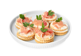 Delicious crackers with cream cheese, prosciutto and parsley on white background