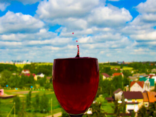 a glass of wine with drops