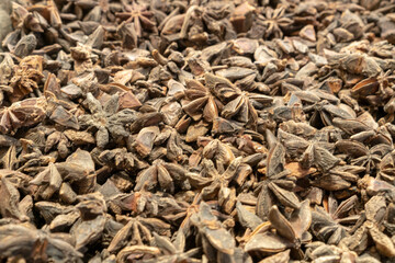 Illicium verum - a spice commonly called star anise, staranise, star anise seed, Chinese star anise, or badian. Top view blur textures soft focus.