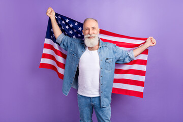 Photo of aged handsome man hold usa flag patriotism national symbol isolated over violet color background