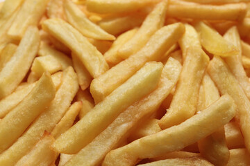 Yummy French fries as background, closeup view