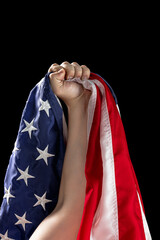 Fototapeta premium Human hand holding national American flag. USA Memorial Day, Labour Day, Independence Day public holidays.