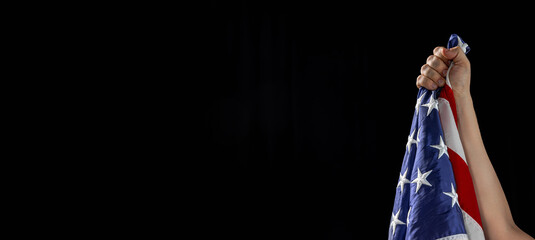 Human hand holding national American flag. USA Memorial Day, Labour Day, Independence Day public holidays.