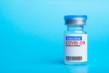 Vaccine bottles on blue background. Vaccine protect Covid-19 or coronavirus.