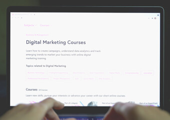 Laptop screen with open website offering online Digital Marketing courses. Online Marketing education online learning concept. Digital knowledge development. Education website. Proficiency hard skills