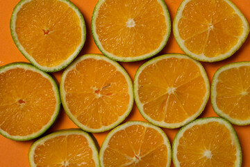 orange fruit slices on orange summer background