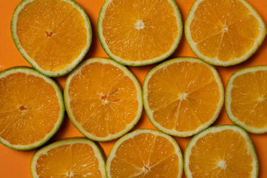 orange fruit slices on orange summer background