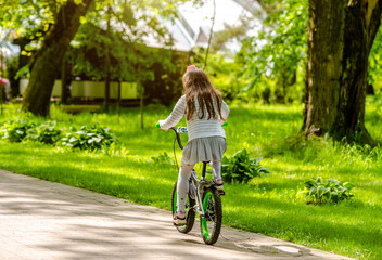 Fototapeta premium Girl ride on the bike path in the city Park 