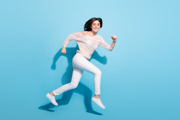 Fototapeta na wymiar Full length profile side photo of happy joyful young lady jump up run sale empty space isolated on blue color background