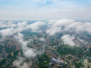 High flight above the clouds in Kiev. Spring morning. Aerial high view.