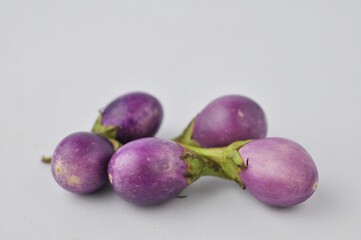 fresh purple round eggplant isolated from white background