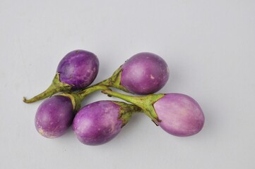 fresh purple round eggplant isolated from white background