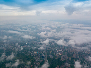 Fototapeta premium High flight above the clouds in Kiev. Spring morning. Aerial high view.