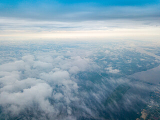 High flight above the clouds in Kiev. Spring morning. Aerial high view.