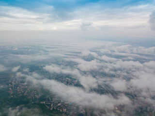 High flight above the clouds in Kiev. Spring morning. Aerial high view.