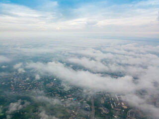 High flight above the clouds in Kiev. Spring morning. Aerial high view.