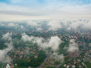 High flight above the clouds in Kiev. Spring morning. Aerial high view.