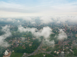 High flight above the clouds in Kiev. Spring morning. Aerial high view.